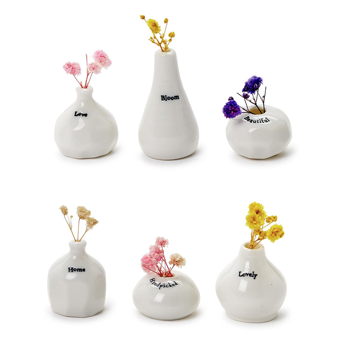 Six tiny white porcelain word vases, each with a small bunch of colorful dried flowers