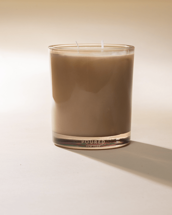 Shroom Bloom candle in a tinted glass tumbler, side view