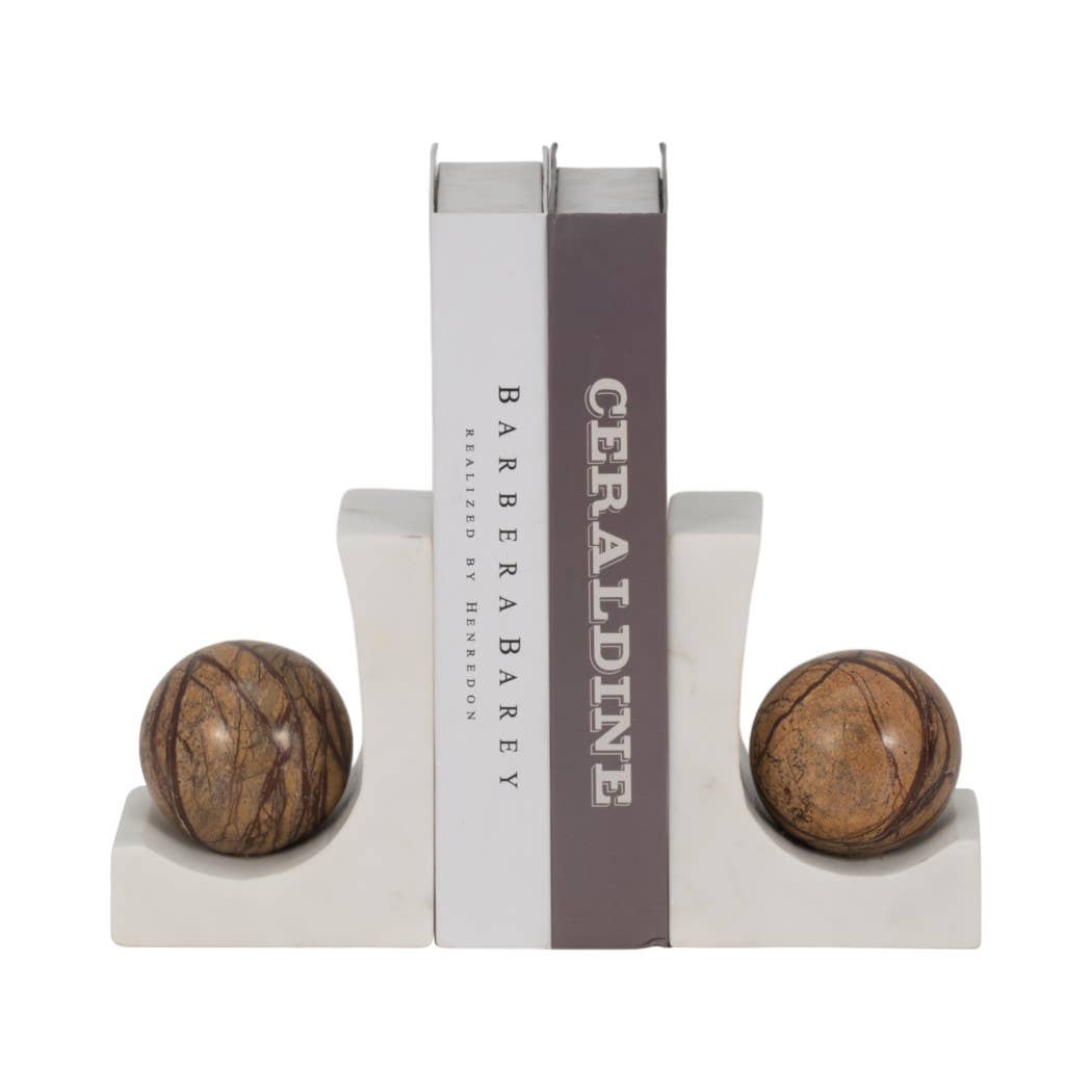 White marble bookends topped with brown marble spheres holding two books