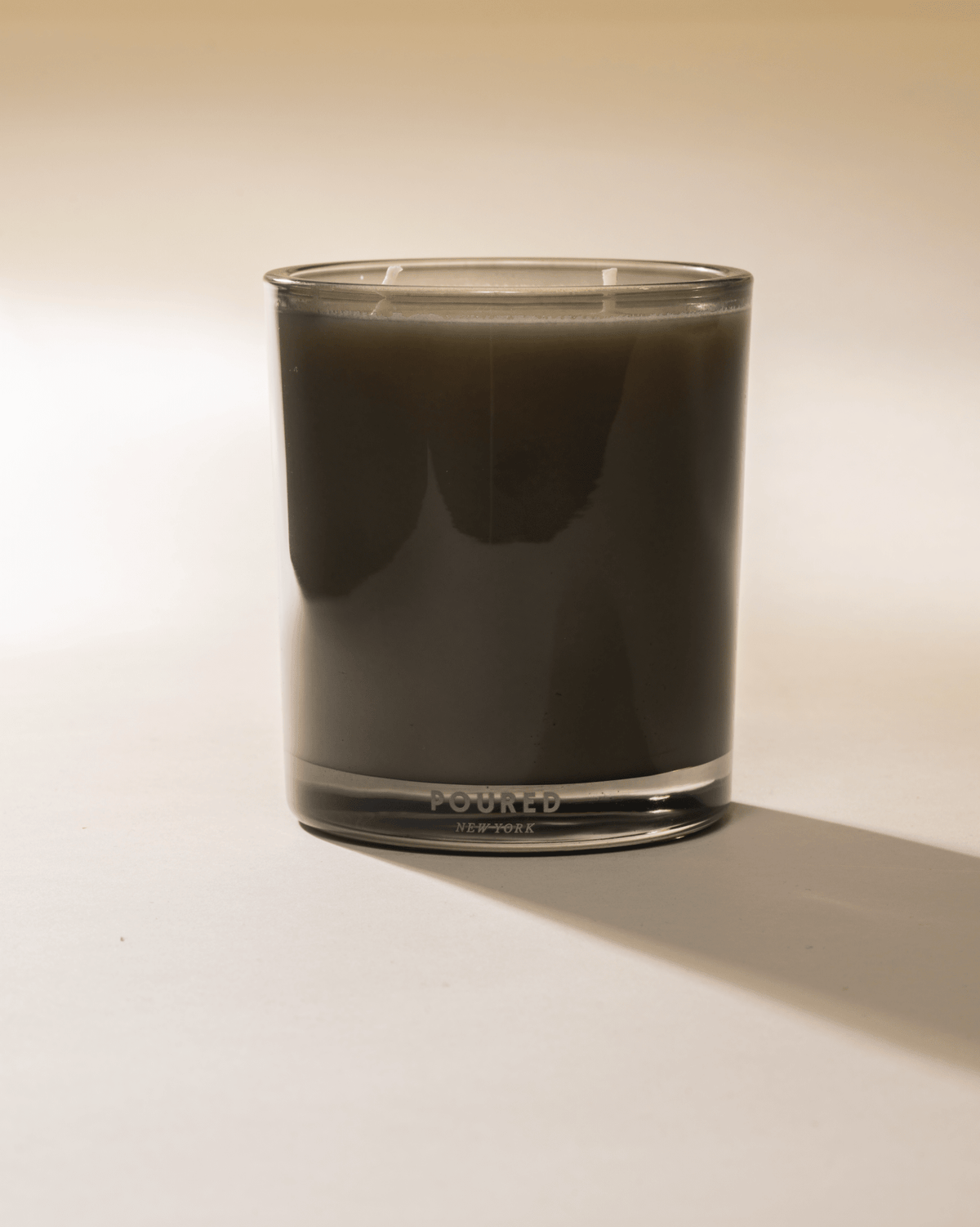 Dirty Girl Martini candle in a smoky glass tumbler, side view
