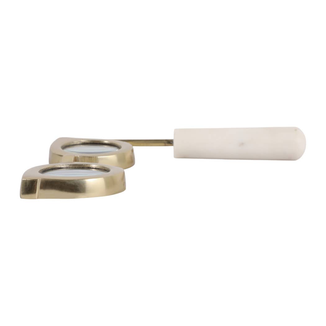 Gold and marble magnifying glass lying flat, side view