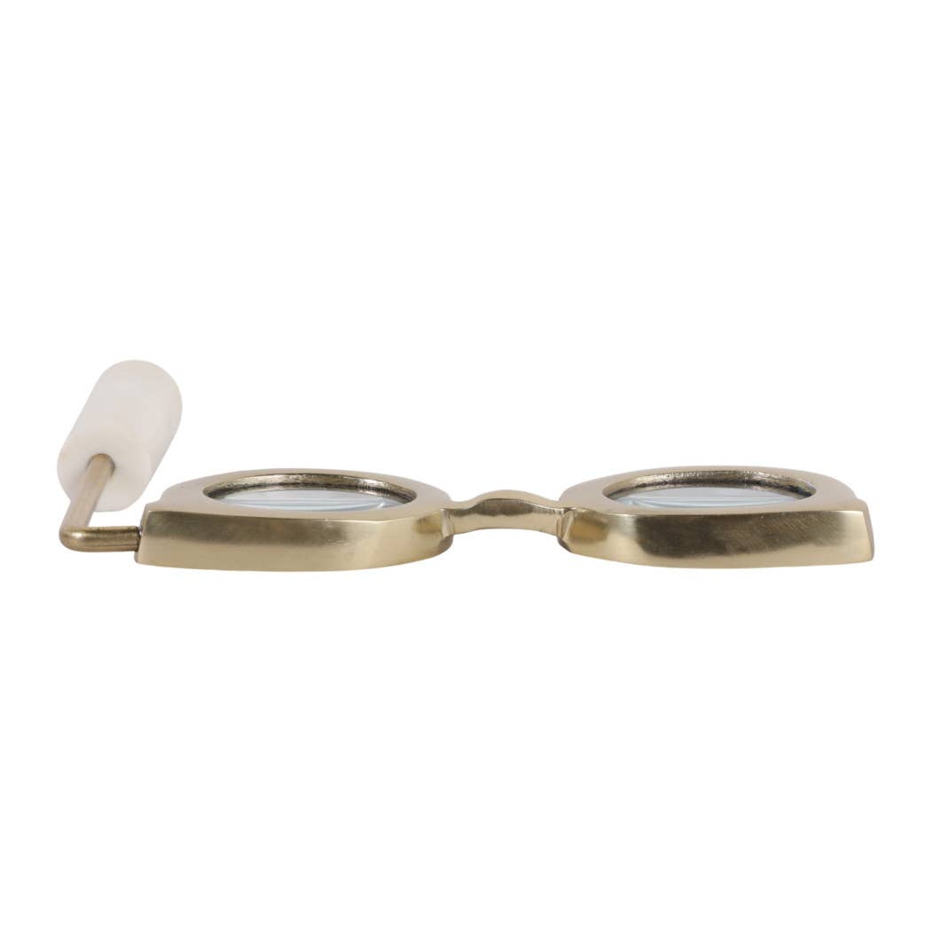 Gold and marble magnifying glass lying flat, top edge view