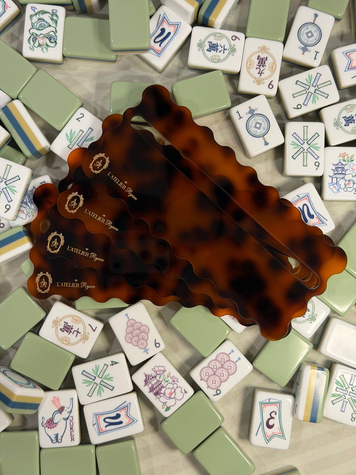 Tortoiseshell Mahjong line readers scattered on a pile of Mahjong tiles