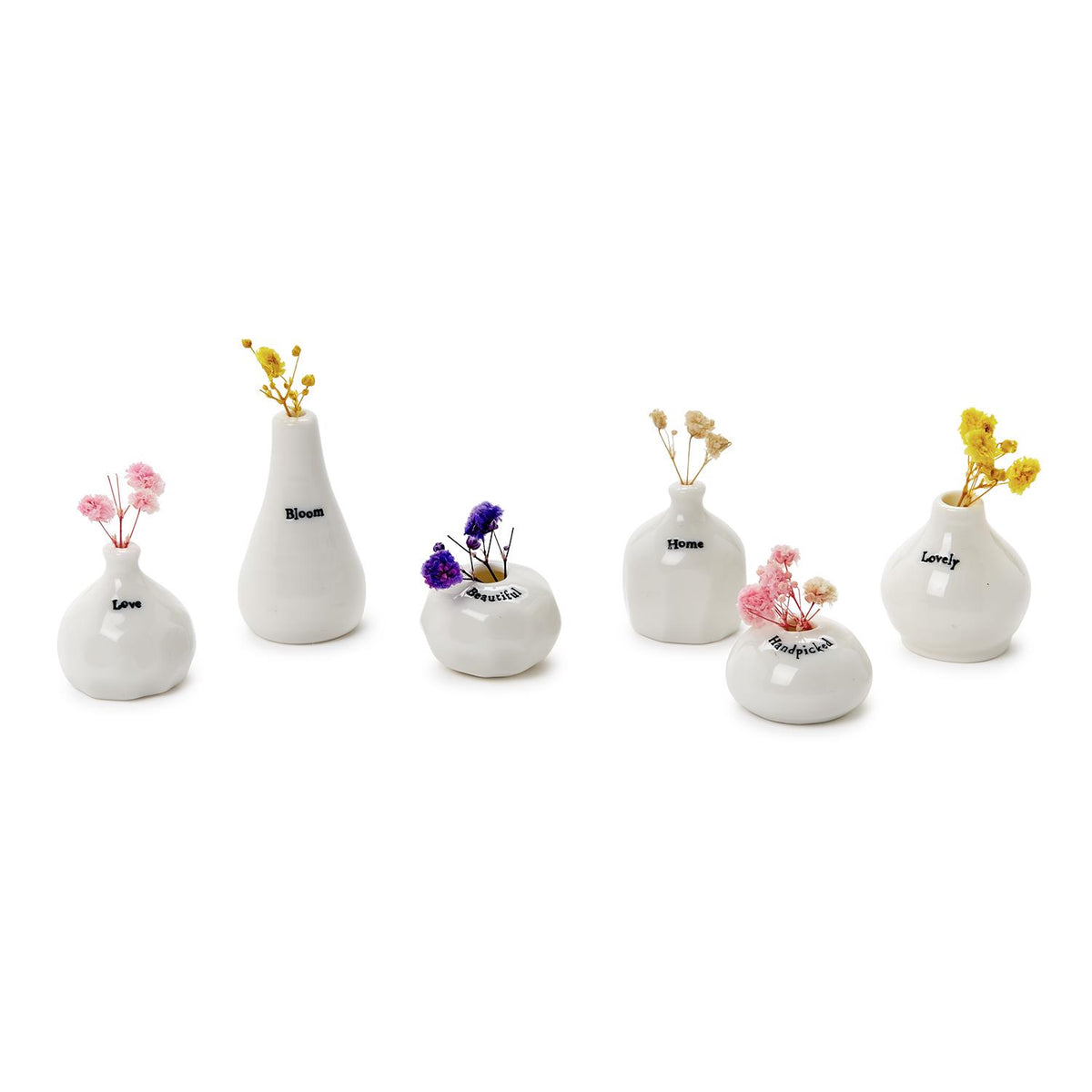 Six tiny white porcelain vases with dried flowers in pink, yellow and purple
