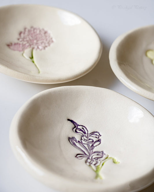 Cream ceramic birth flower ring dishes with pink and purple flower designs