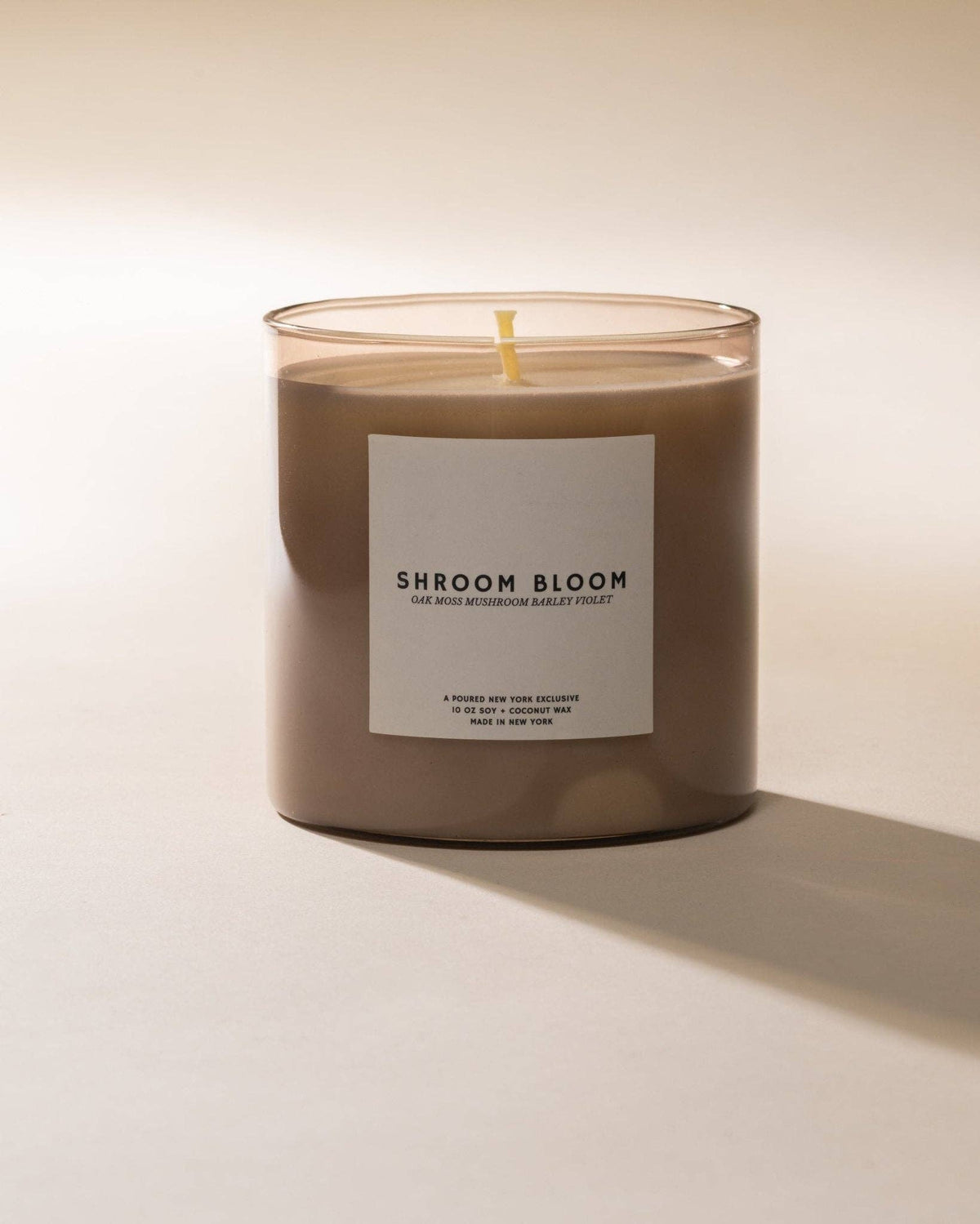Shroom Bloom soy coconut wax candle in a brown glass jar, front label