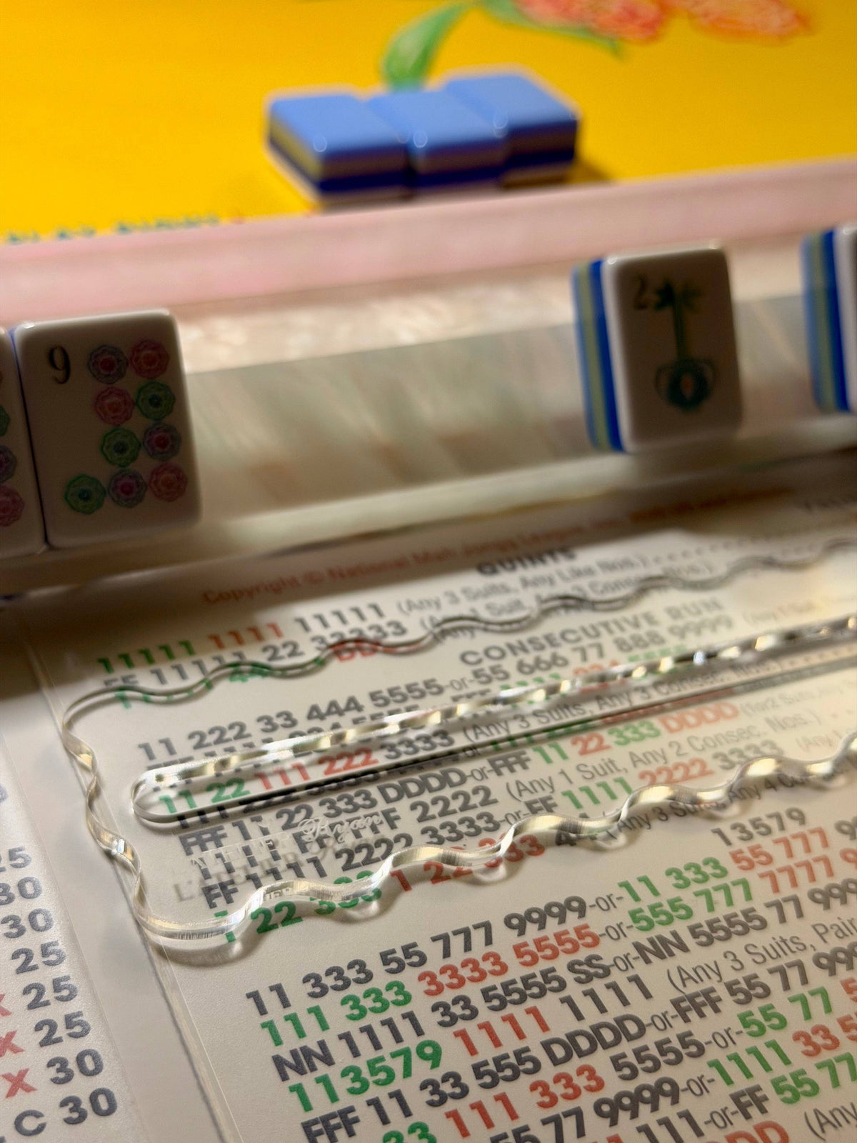 Clear acrylic Mahjong line reader resting on a Mahjong card at a game table