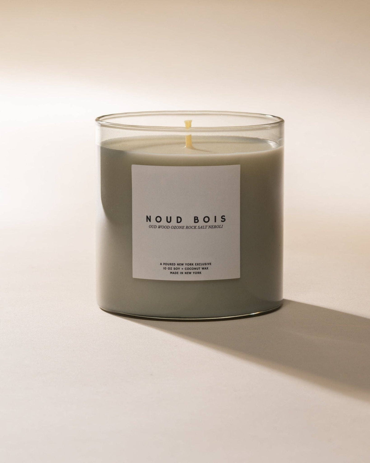 Noud Bois soy coconut wax candle in a sage glass jar, front label