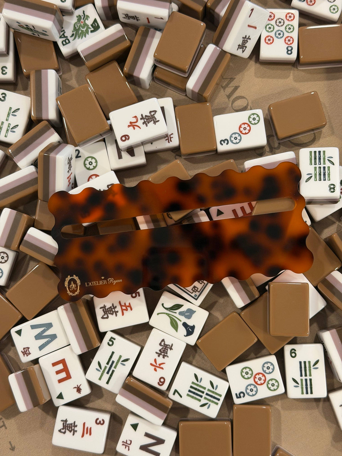 Tortoiseshell Mahjong line reader on a table of Mahjong tiles