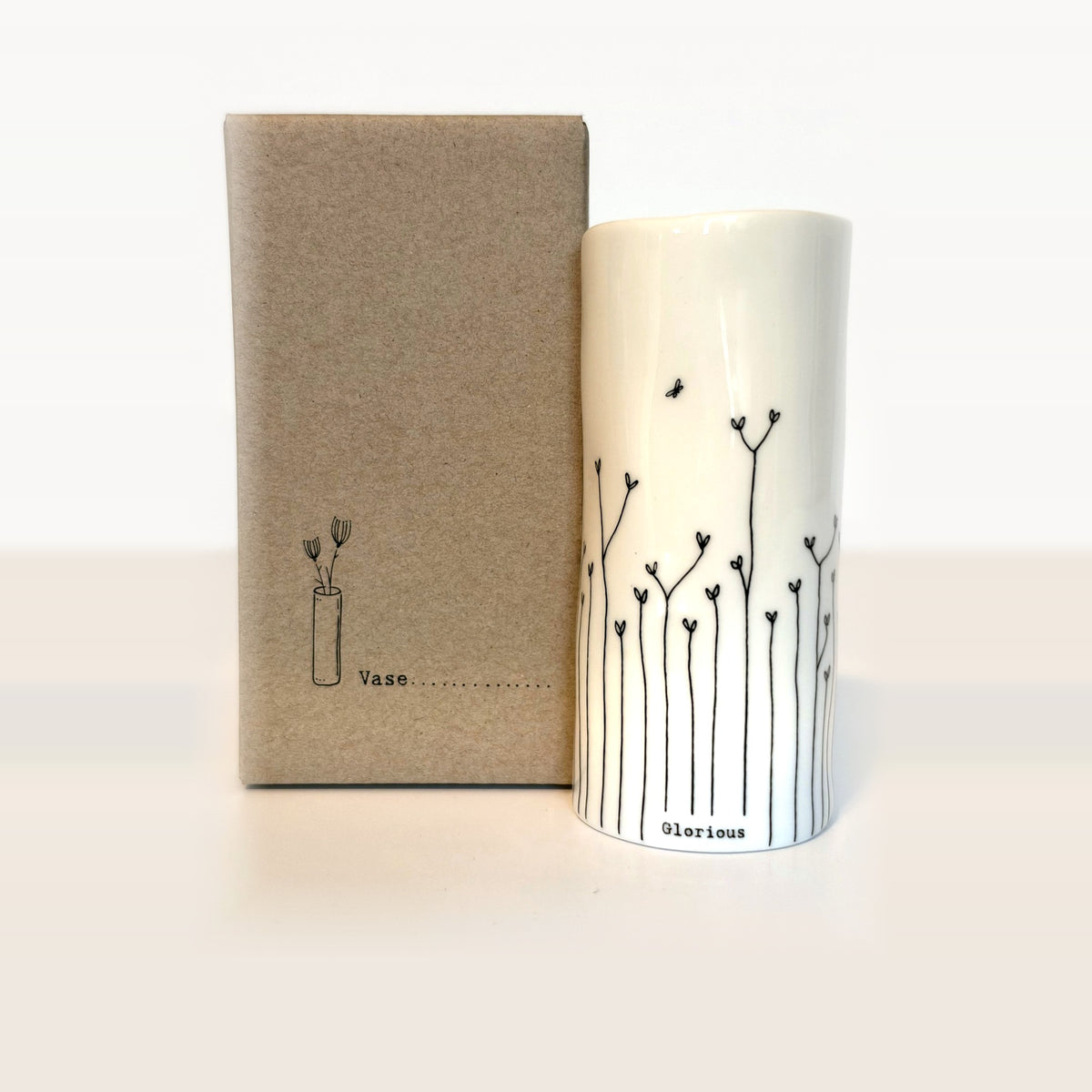 Glorious mini porcelain vase with hand-drawn heart flowers and a tiny bee next to its kraft gift box