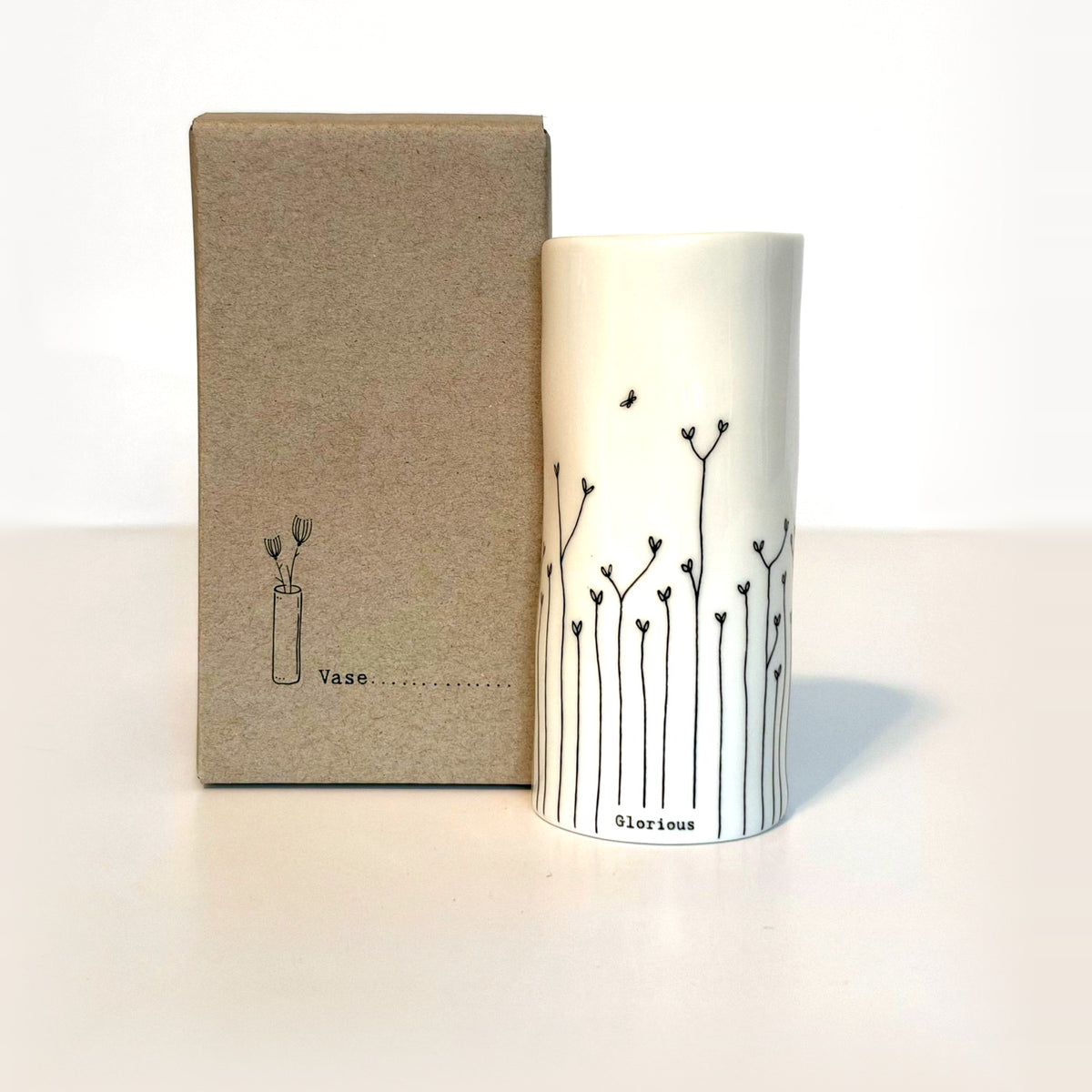Glorious mini porcelain vase with hand-drawn heart flowers and a tiny bee next to its kraft gift box
