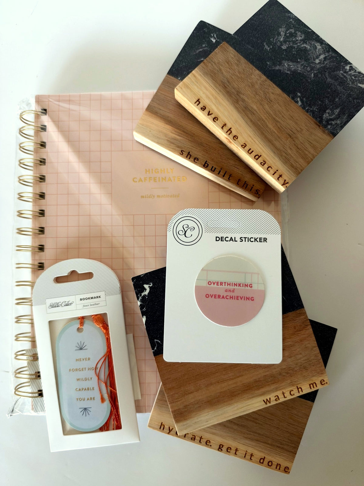She's Got Plans gift set: four engraved black marble and wood women in business coasters, Highly Caffeinated notebook, Never Forget How Wildly Capable You Are bookmark and Overthinking & Overachieving sticker
