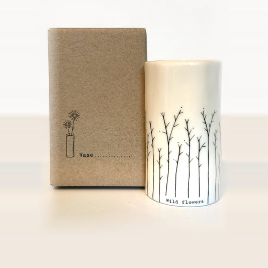Wild flowers mini porcelain vase with hand-drawn branching stems next to its kraft gift box